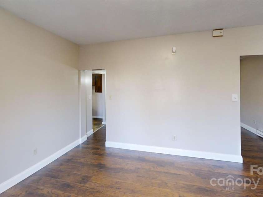 59 Upper Saw Branch Road, Candler, NC 28715.  MLS# CAR4226917, YatesRealty ID 13059. View from entry door to laundry area (L) and den (R).