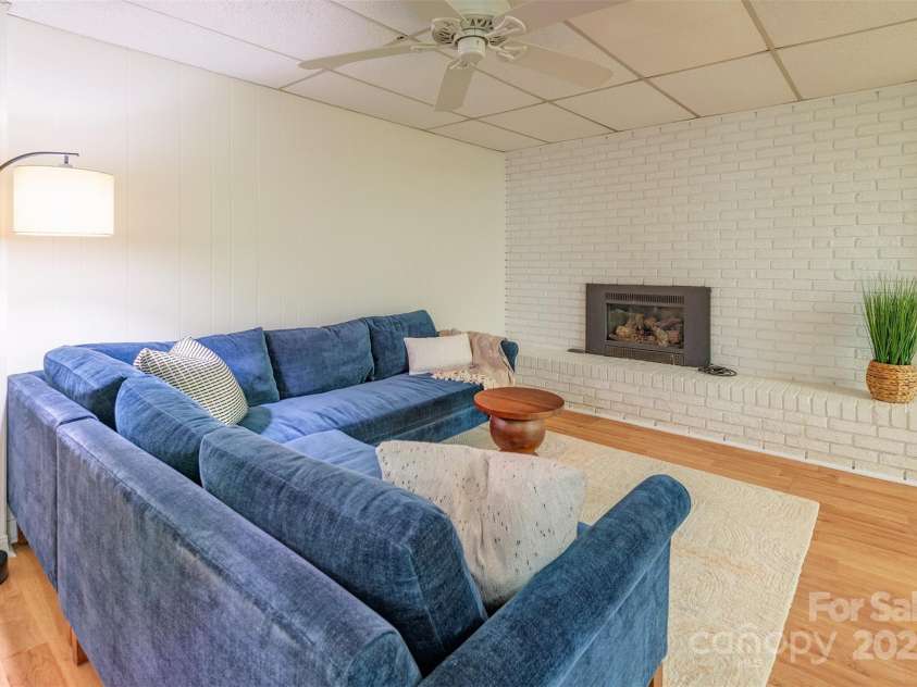 14 Parkview Drive, Asheville, NC 28805.  MLS# CAR4245695, YatesRealty ID 13070. Lower level living room with gas logs fireplace.