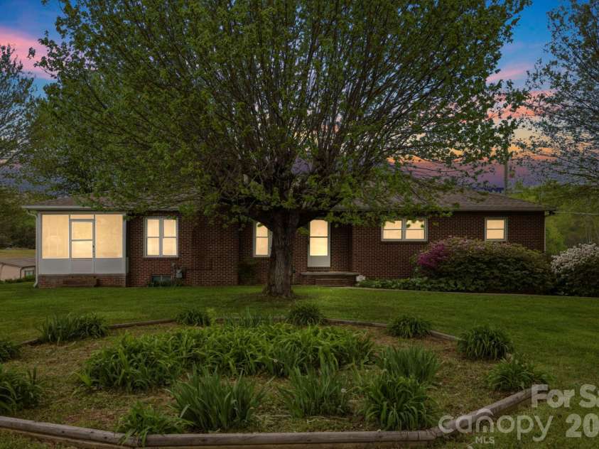 343 Brickyard Road, Etowah, NC 28729.  MLS# CAR4369195, YatesRealty ID 13084. Evening view of the home 