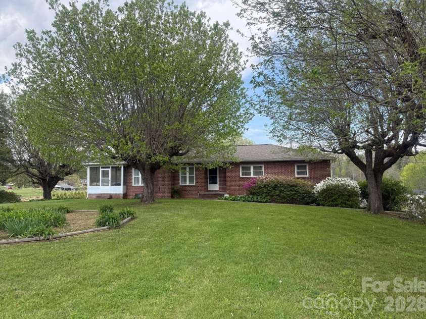 343 Brickyard Road, Etowah, NC 28729.  MLS# CAR4369195, YatesRealty ID 13084. Front view of the home with the large front yard. 