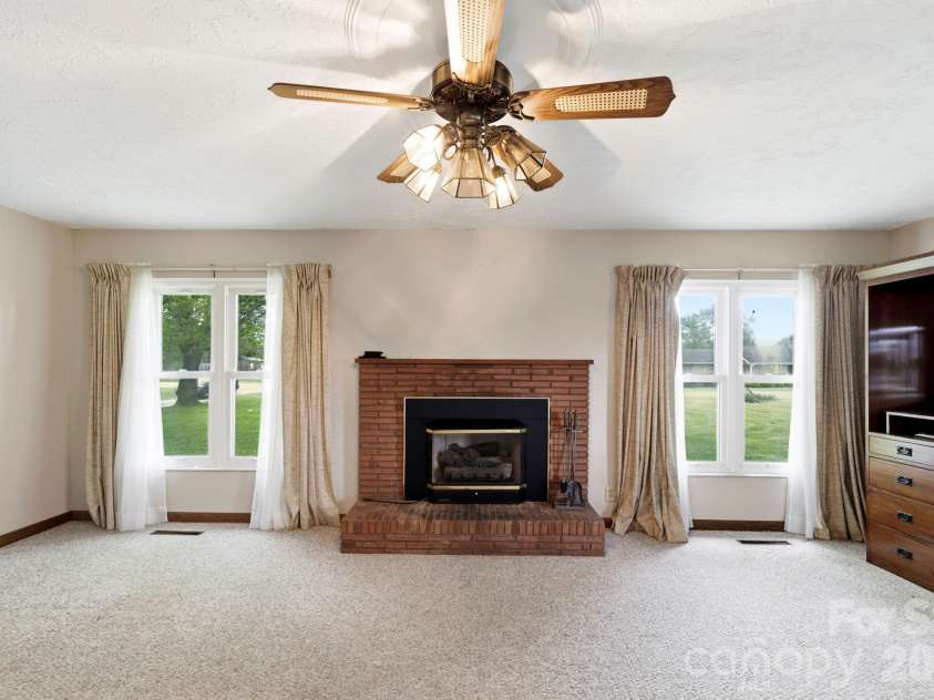 343 Brickyard Road, Etowah, NC 28729.  MLS# CAR4369195, YatesRealty ID 13084. Living room with gas logs. 