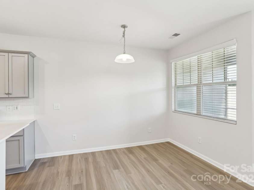 5254 Spanish Ivy Lane, Indian Land, SC 29707.  MLS# CAR4258702, YatesRealty ID 13086. Dining area also looks out to the screened in patio and water fountain!