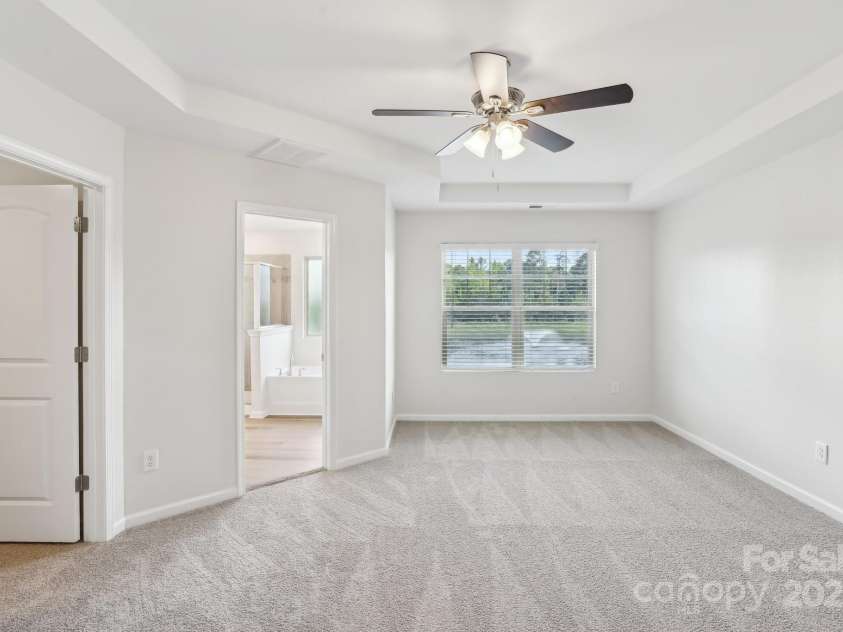 5254 Spanish Ivy Lane, Indian Land, SC 29707.  MLS# CAR4258702, YatesRealty ID 13086. Primary bedroom has space for a small retreat that also looks out to water fountain and woods!