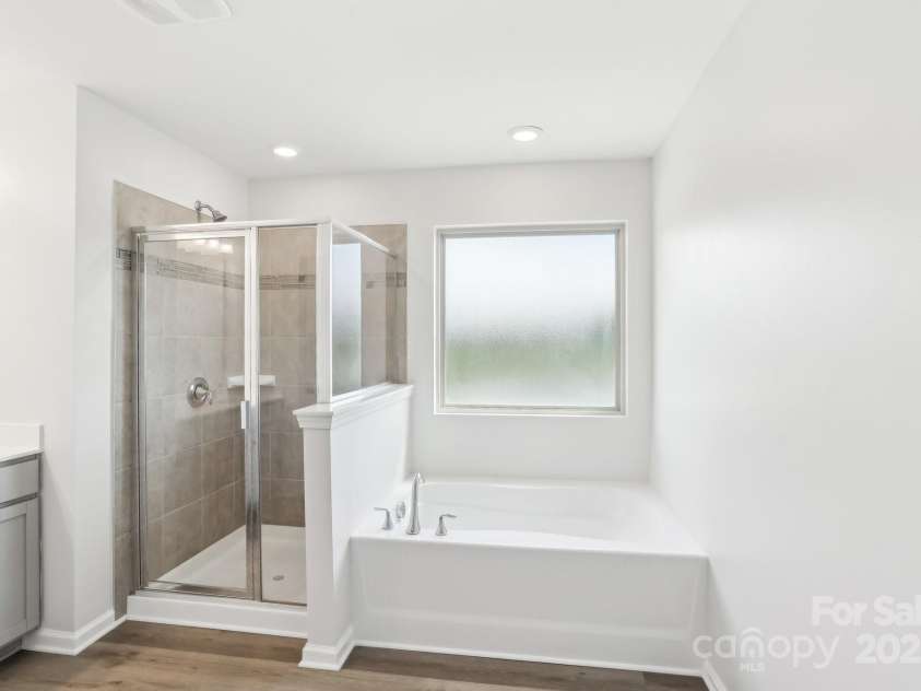 5254 Spanish Ivy Lane, Indian Land, SC 29707.  MLS# CAR4258702, YatesRealty ID 13086. Separate walk-in shower and soaking tub. Upgraded tile surround in shower!