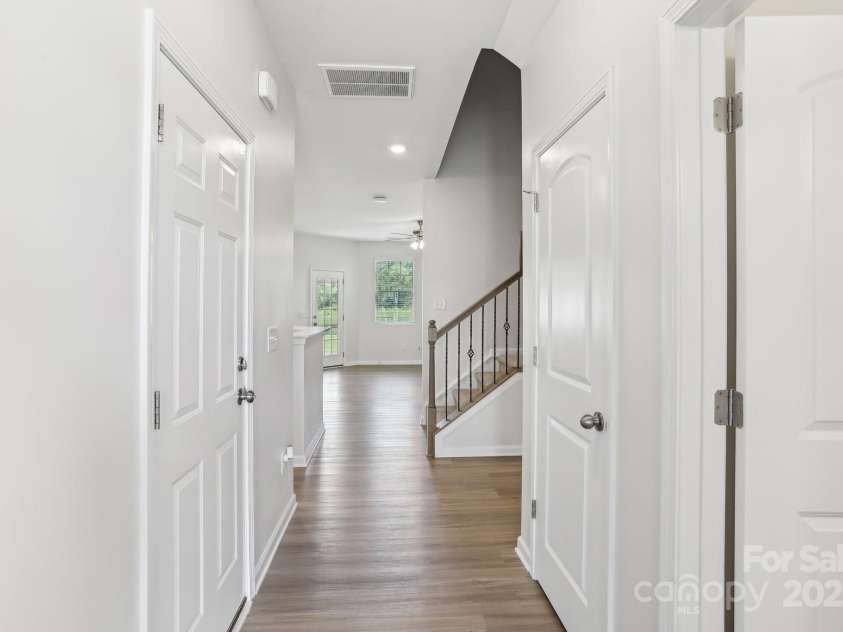 5254 Spanish Ivy Lane, Indian Land, SC 29707.  MLS# CAR4258702, YatesRealty ID 13086. You are greeted with beautiful luxury vinyl plank flooring with space for a drop zone or mud rack just to the right! Then notice the upgraded wrought iron stair spindles and wood rails.