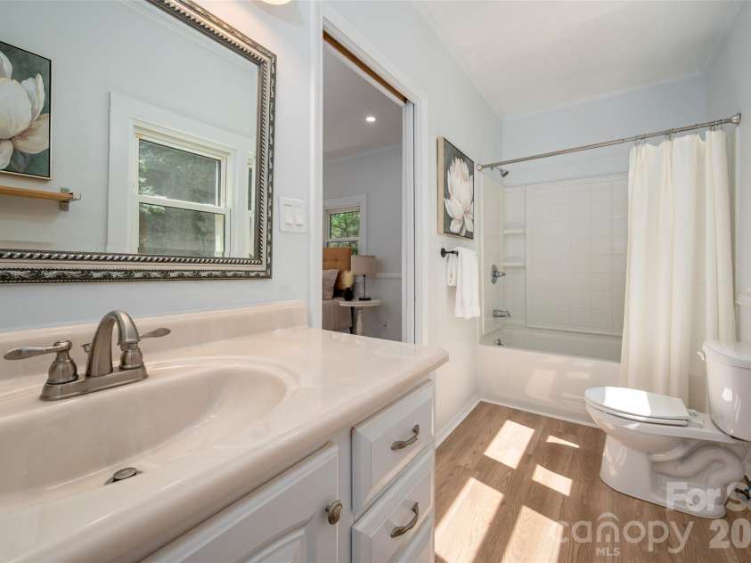 782 Ideal Drive, Concord, NC 28025.  MLS# CAR4370544, YatesRealty ID 13093. Primary bathroom with new plank flooring.