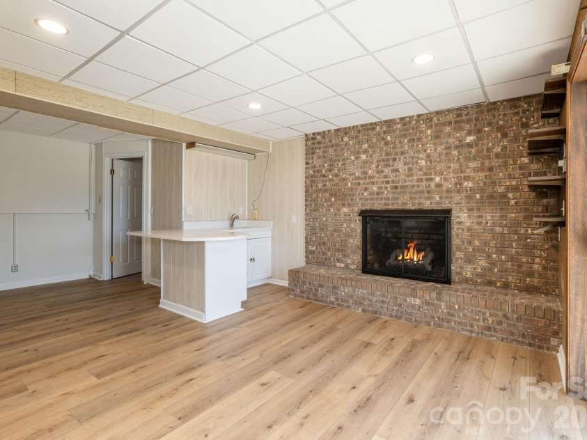 3113 Primrose Drive, Hendersonville, NC 28792.  MLS# CAR4359967, YatesRealty ID 13099. Lower level den with wet bar