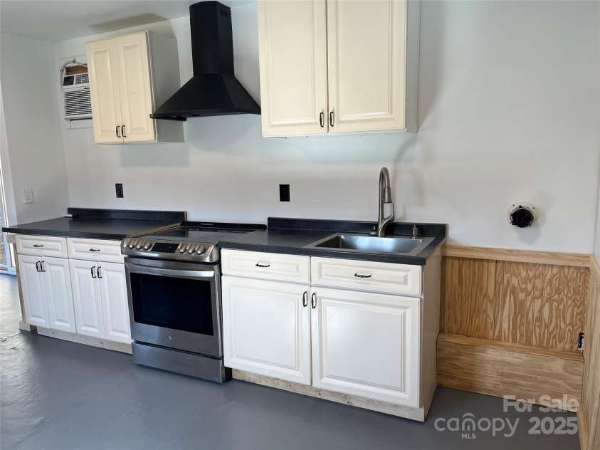 1961 Cane Creek Road, Fletcher, NC 28732.  MLS# CAR4233282, YatesRealty ID 131. Laundry area in kitchen