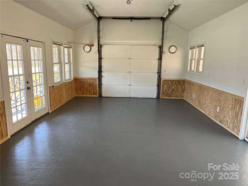 1961 Cane Creek Road, Fletcher, NC 28732.  MLS# CAR4233282, YatesRealty ID 131. Main room with front door, rear door and garage door