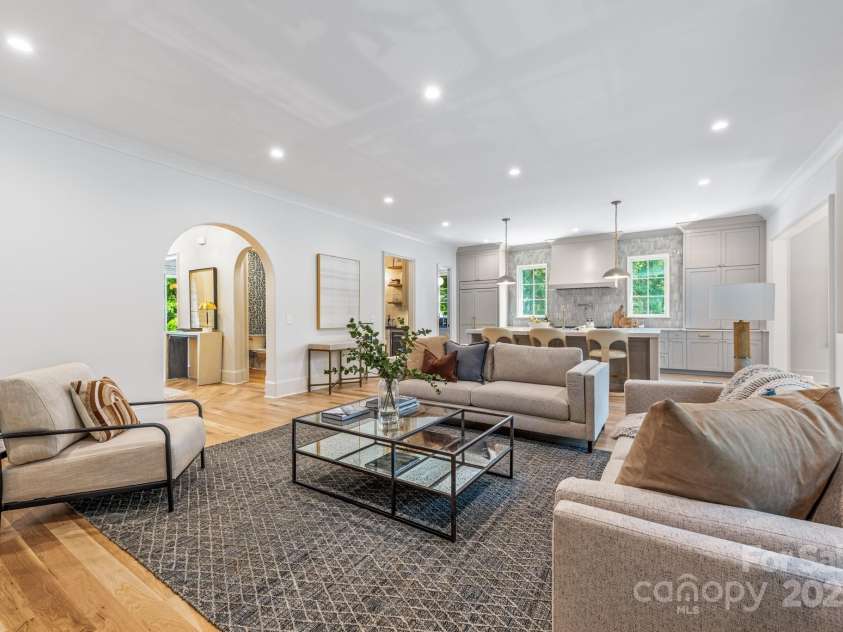 5601 Robinhood Road, Charlotte, NC 28211.  MLS# CAR4258800, YatesRealty ID 13109. Great Room and Kitchen.  The powder room is through the arched doorway