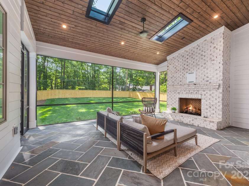 5601 Robinhood Road, Charlotte, NC 28211.  MLS# CAR4258800, YatesRealty ID 13109. Great screened porch with fireplace