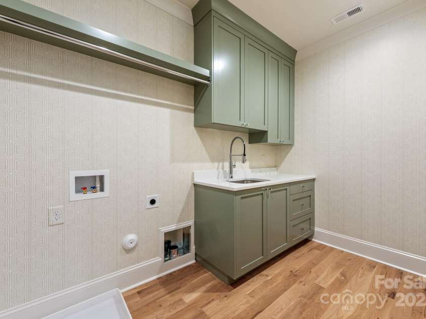 5601 Robinhood Road, Charlotte, NC 28211.  MLS# CAR4258800, YatesRealty ID 13109. Laundry Room with built-in cabinetry and a soaking sink
