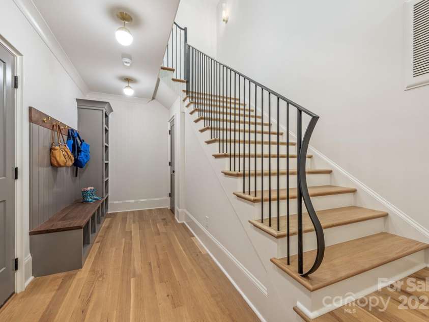 5601 Robinhood Road, Charlotte, NC 28211.  MLS# CAR4258800, YatesRealty ID 13109. Stairs lead down to the basement and drop zone.  The door on the left leads to the 3 car garage.