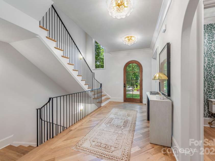 5601 Robinhood Road, Charlotte, NC 28211.  MLS# CAR4258800, YatesRealty ID 13109. View of front Foyer, Powder Room, and stairways leading upstairs and to Basement Garage
