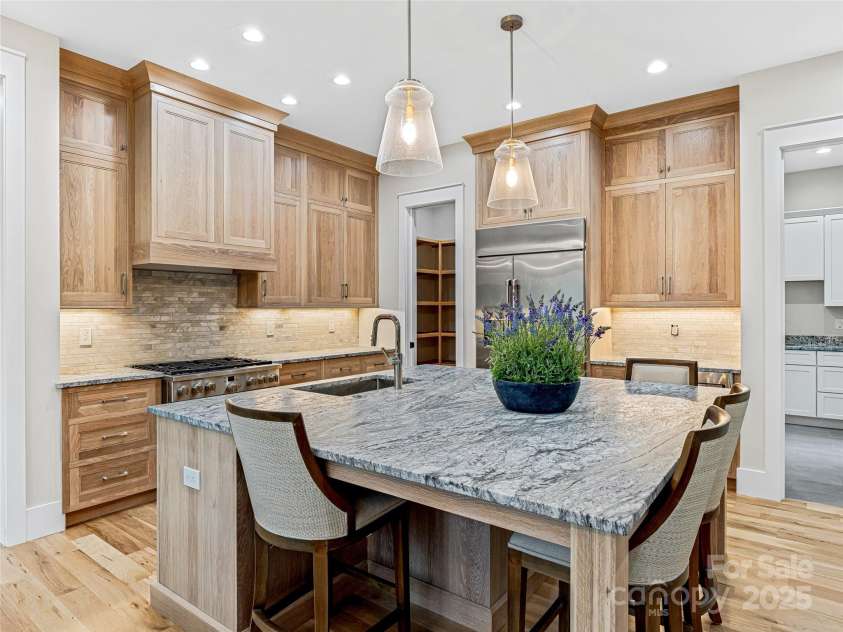 435 Barrington Drive, Asheville, NC 28803.  MLS# CAR4235274, YatesRealty ID 13124. Expansive kitchen island with granite countertops