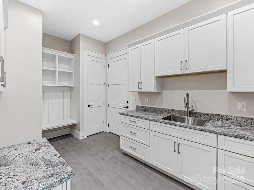 435 Barrington Drive, Asheville, NC 28803.  MLS# CAR4235274, YatesRealty ID 13124. Main level laundry room with plenty of storage