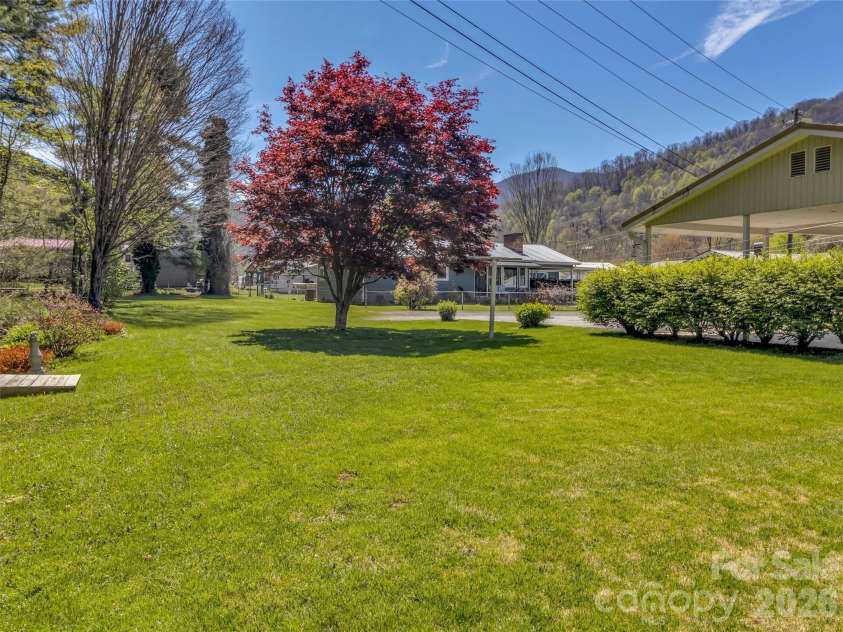 68 Skyview Drive, Waynesville, NC 28786.  MLS# CAR4368765, YatesRealty ID 13140. Side yard