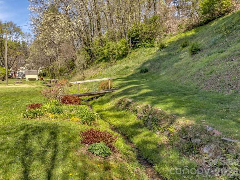 68 Skyview Drive, Waynesville, NC 28786.  MLS# CAR4368765, YatesRealty ID 13140. Stream on side yard