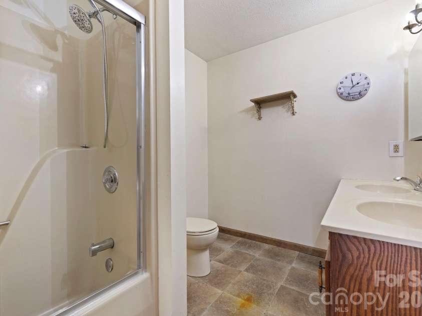 40 Country Bear Lane, Flat Rock, NC 28731.  MLS# CAR4332498, YatesRealty ID 13148. En suite bathroom off flex space with dual sinks