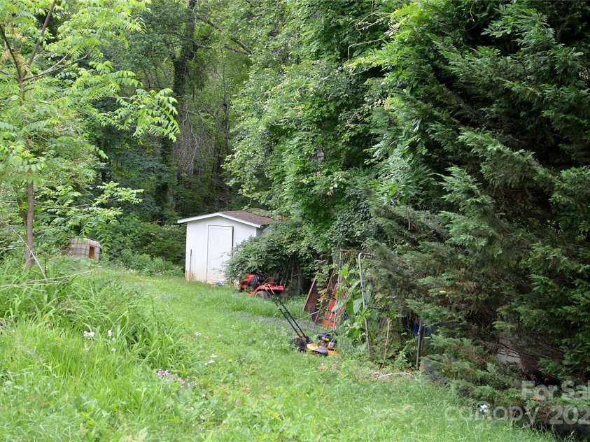447 Harmony Grove Road, Nebo, NC 28761.  MLS# CAR4253632, YatesRealty ID 13167. Back yard with sh
