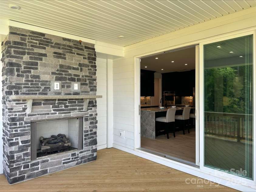 5225 Glenwalk Drive, Charlotte, NC 28269.  MLS# CAR4166267, YatesRealty ID 13180. Exterior Fireplace and Multi-Slider door on private, covered deck