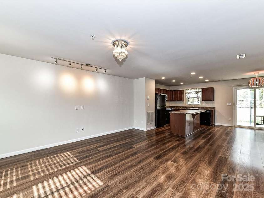 1128 Tangle Ridge Drive, Concord, NC 28025.  MLS# CAR4219429, YatesRealty ID 1319. Living Room and Kitchen