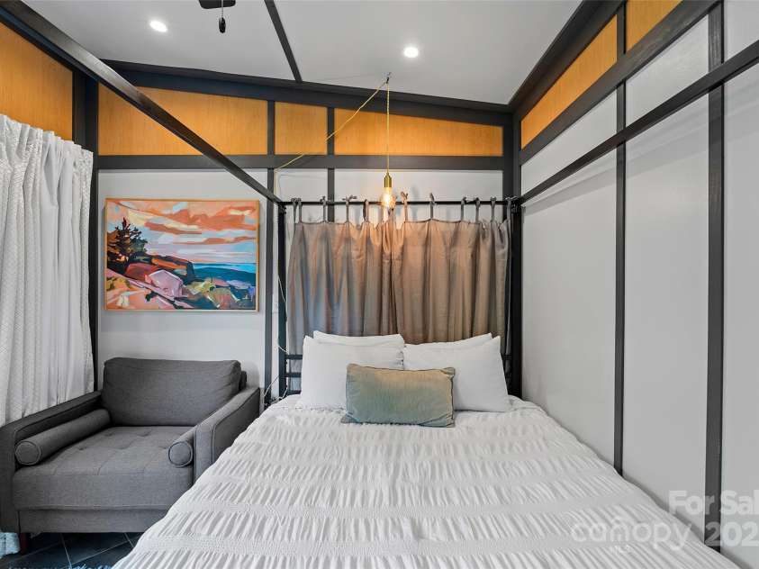 787 Ridge Road, Marion, NC 28752.  MLS# CAR4257578, YatesRealty ID 13209. MINI - Studio bedroom in living area w/ cozy chair