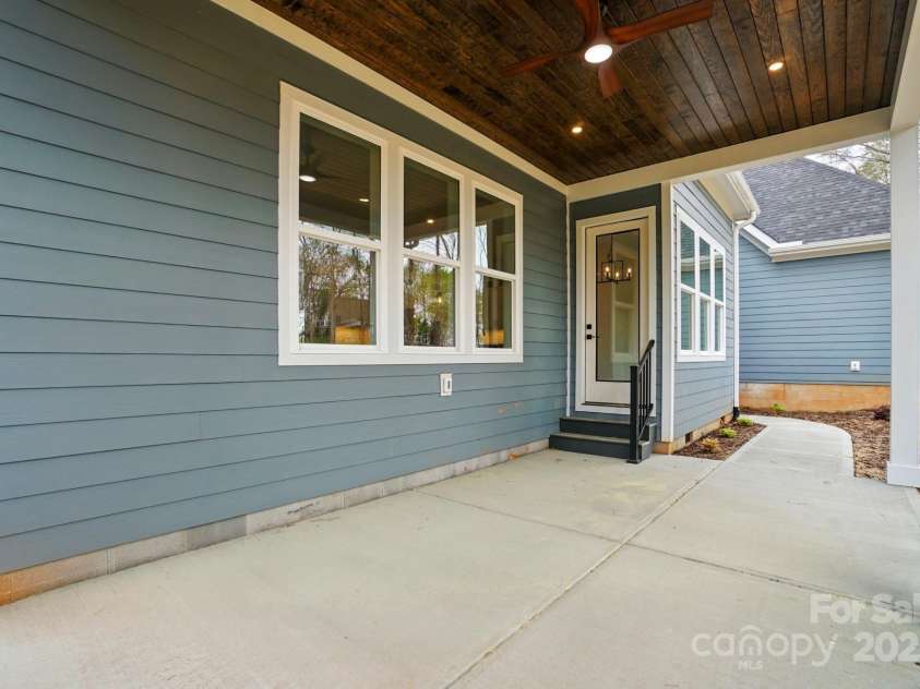 149 Shady Cove Road, Troutman, NC 28166.  MLS# CAR4252387, YatesRealty ID 13223. Covered patio with paneled wood accent & ceiling fan