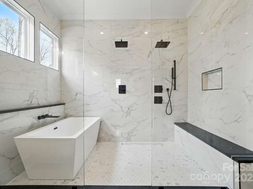 149 Shady Cove Road, Troutman, NC 28166.  MLS# CAR4252387, YatesRealty ID 13223. Glass enclosed wet room with deep soaking tub & dual shower heads