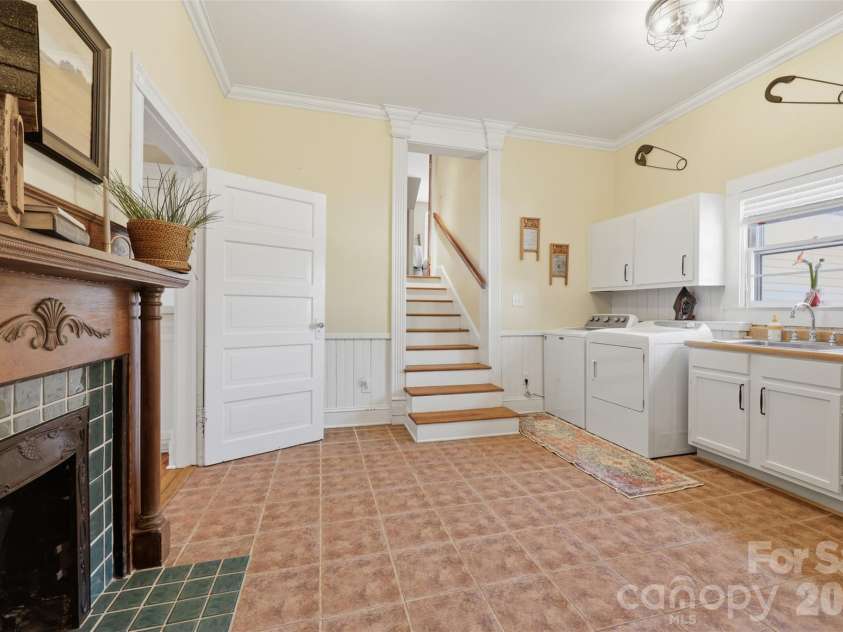 8 Vance Street, Lexington, NC 27292.  MLS# CAR4369214, YatesRealty ID 13224. Laundry room with sink and non-working fireplace