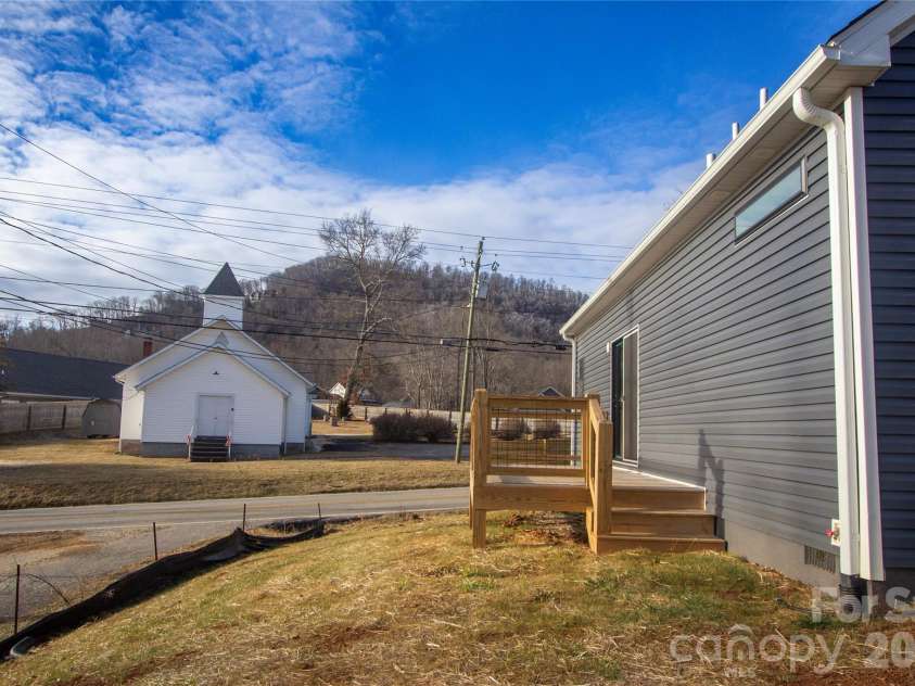 203 Southern Charm Road, Arden, NC 28704.  MLS# CAR4342838, YatesRealty ID 1323. Sunny rear deck w/ Mountain and chapel views