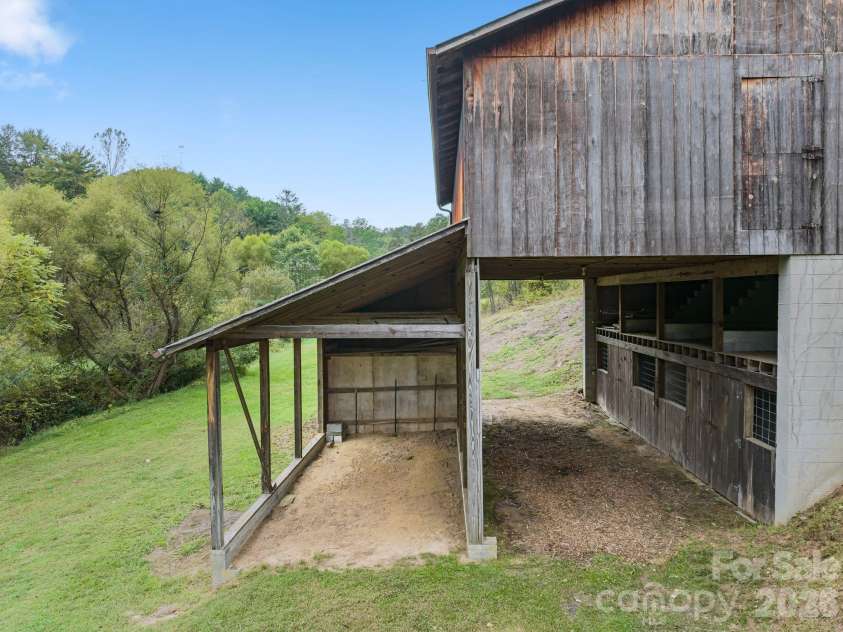 25 Mezzo Cove, Asheville, NC 28804.  MLS# CAR4308363, YatesRealty ID 13232. Barn with covered parking for tractors