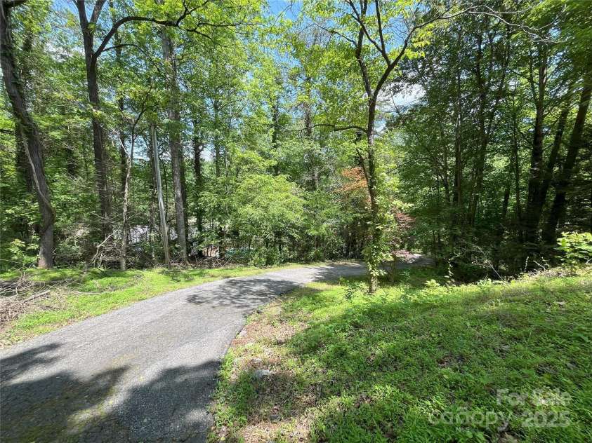 243 Buffalo Creek Road, Lake Lure, NC 28746.  MLS# CAR4219032, YatesRealty ID 13241. Long driveway sets the home back high and dry, away from the creek and road.