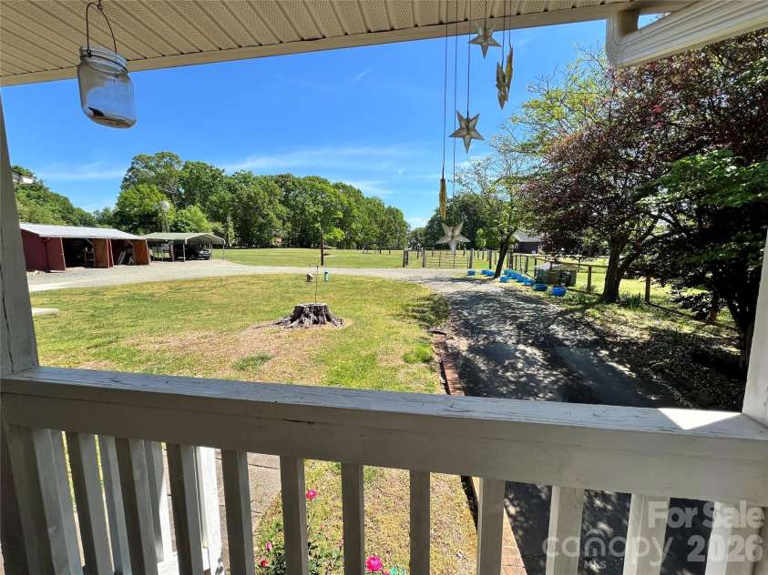 24530 Ridgecrest Road, Locust, NC 28097.  MLS# CAR4369926, YatesRealty ID 13247. Covered Side Porch view of backyard