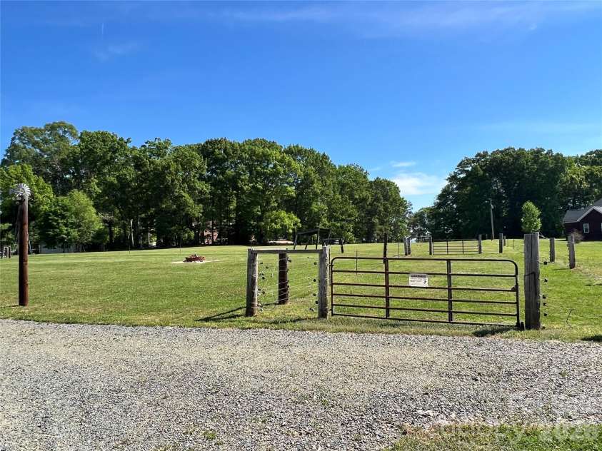 24530 Ridgecrest Road, Locust, NC 28097.  MLS# CAR4369926, YatesRealty ID 13247. Fenced Back Acreage