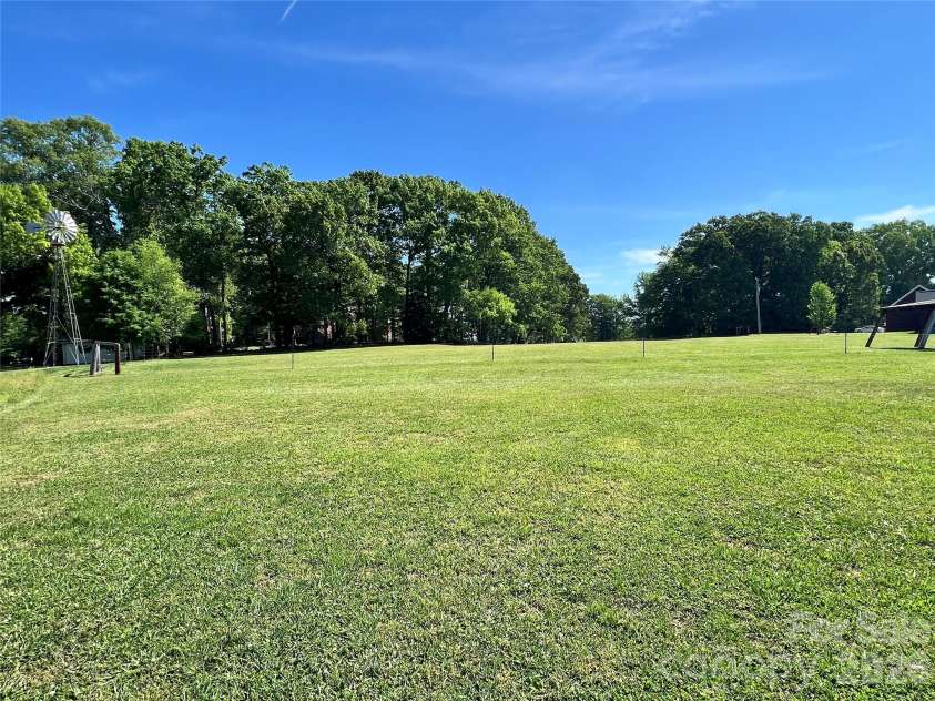 24530 Ridgecrest Road, Locust, NC 28097.  MLS# CAR4369926, YatesRealty ID 13247. Fenced Back Acreage