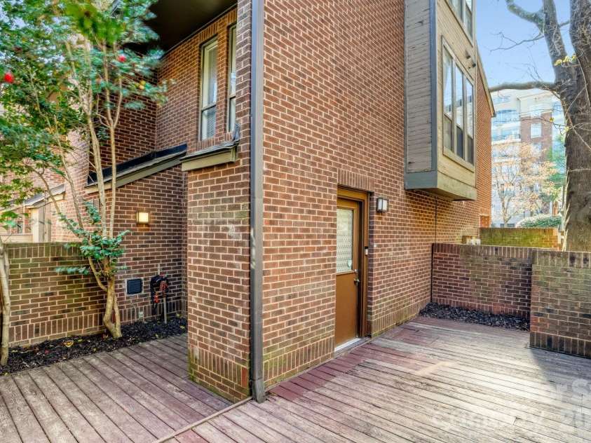 417 Church Street, Charlotte, NC 28202.  MLS# CAR4358979, YatesRealty ID 13254. Enclosed by a brick wall and a gate. 