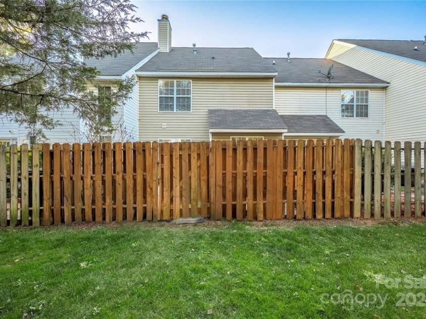4507 Antelope Lane, Charlotte, NC 28269.  MLS# CAR4225453, YatesRealty ID 13277. Grass area on other side of fence