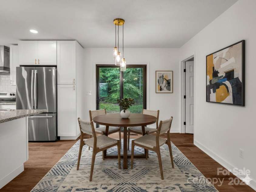 30 Patti Drive, Fletcher, NC 28732.  MLS# CAR4296193, YatesRealty ID 13283. Dining room opens up to backyard with brand new deck. (Virtually Staged)