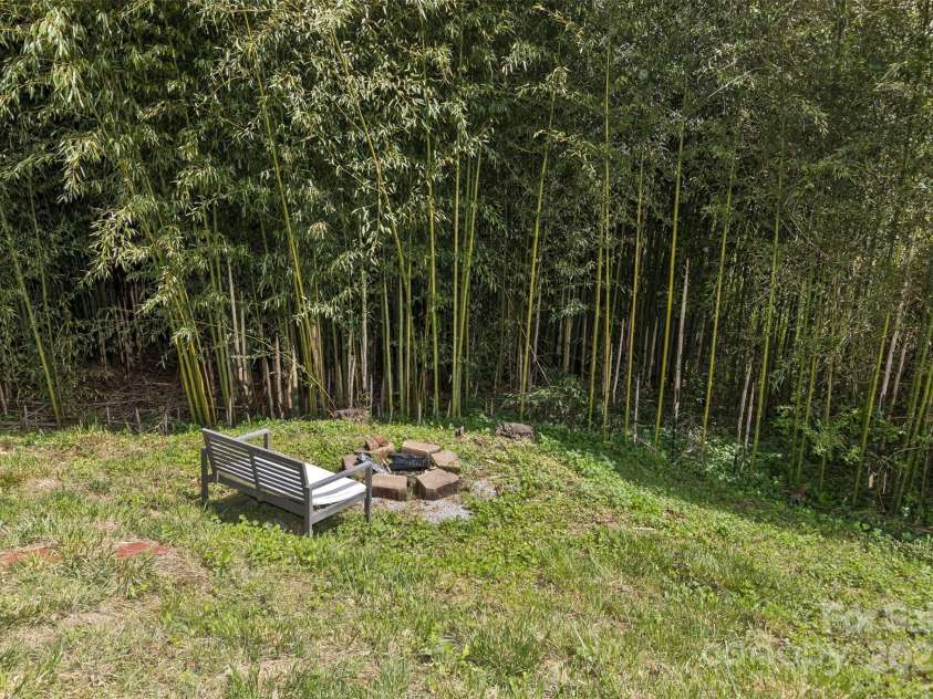 27 Townview Drive, Asheville, NC 28806.  MLS# CAR4247652, YatesRealty ID 13292. Side yard fire pit amongst the bamboo.