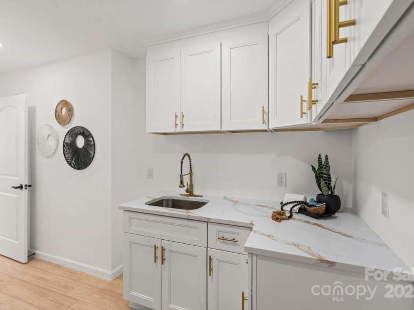 5910 Grosner Place, Charlotte, NC 28211.  MLS# CAR4257156, YatesRealty ID 13296. Laundry room with lots of storage.