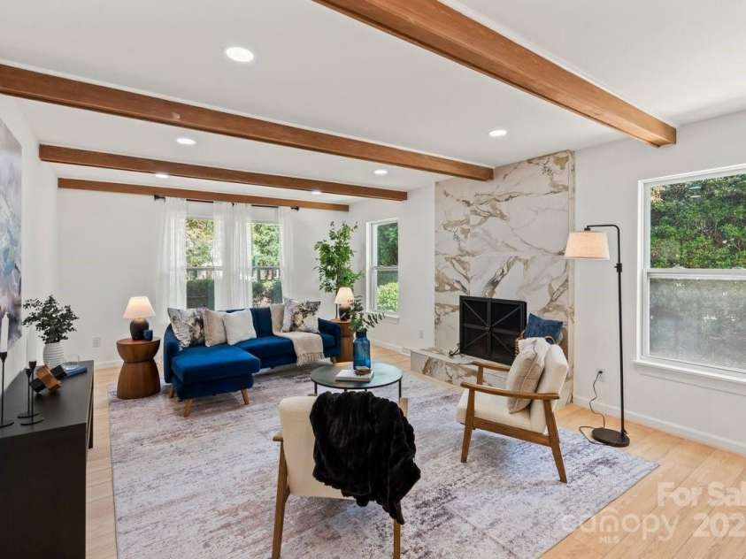 5910 Grosner Place, Charlotte, NC 28211.  MLS# CAR4257156, YatesRealty ID 13296. Your family room with fireplace and wood beams!