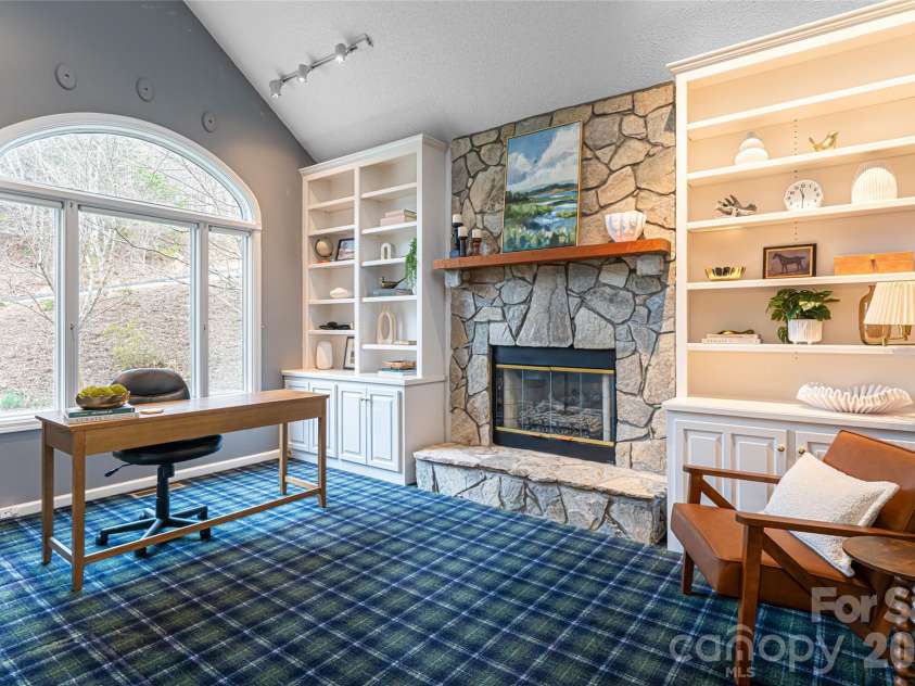65 Timber Park Drive, Black Mountain, NC 28711.  MLS# CAR4344889, YatesRealty ID 13296. Office space or possible den with built-in's and a stone fireplace