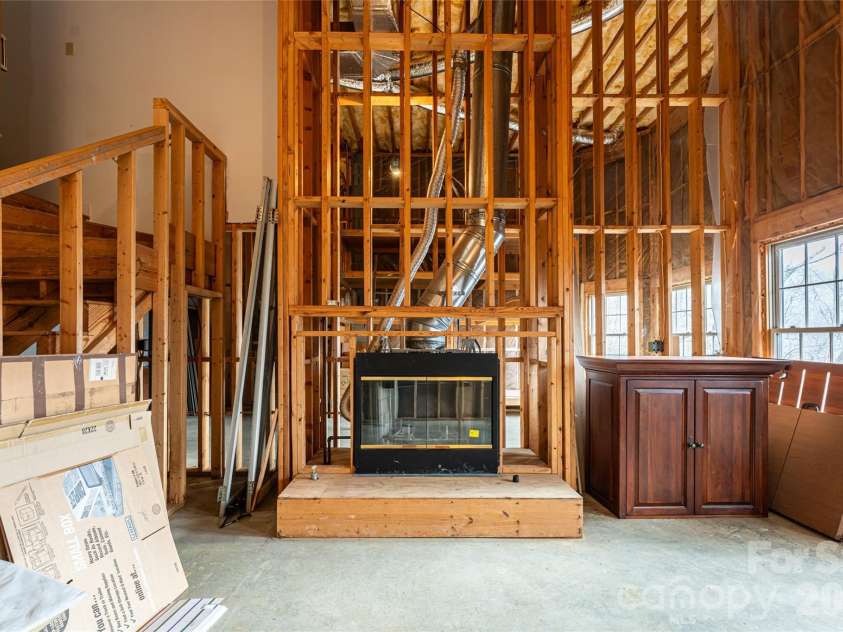 65 Timber Park Drive, Black Mountain, NC 28711.  MLS# CAR4344889, YatesRealty ID 13296. Unfinished basement featuring soaring ceilings and fireplace