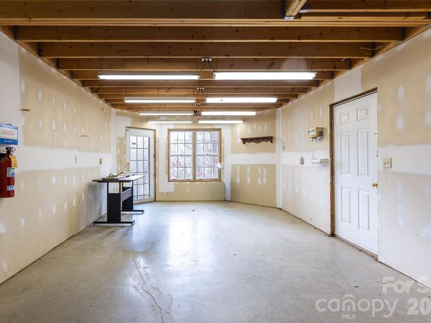 65 Timber Park Drive, Black Mountain, NC 28711.  MLS# CAR4344889, YatesRealty ID 13296. Unfinished basement space is perfect for expanding or using it as a workshop