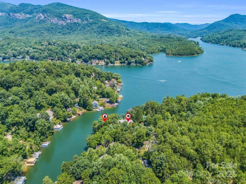 197 Hawthorne Drive, Lake Lure, NC 28746.  MLS# CAR4154813, YatesRealty ID 133. Aerial view of Lake Lure, markers show the boat house (L) and home location (R).