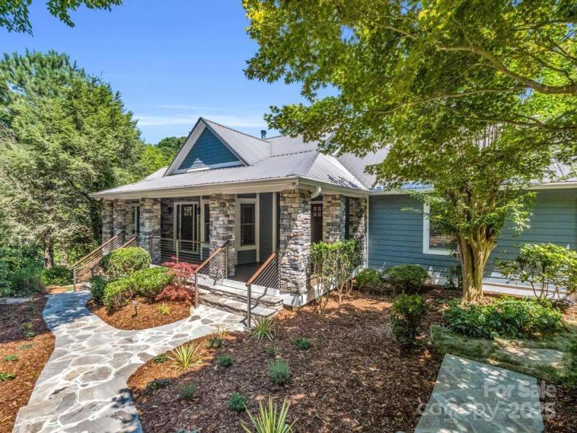 197 Hawthorne Drive, Lake Lure, NC 28746.  MLS# CAR4154813, YatesRealty ID 133. Stonework & beautiful landscaping at the inviting front entrance.