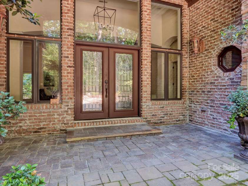 225 Riverton Road, Weddington, NC 28104.  MLS# CAR4306404, YatesRealty ID 13305. Leaded glass door entry, Large windows that invite the nature in