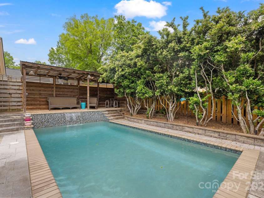 2306 Club Road, Charlotte, NC 28205.  MLS# CAR4250030, YatesRealty ID 13319. Waterfall pool with covered porch and garden seating.