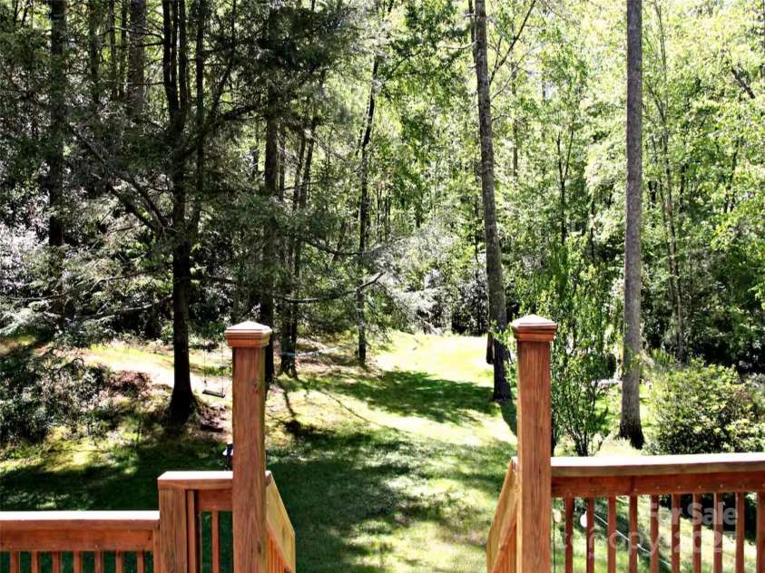 142 Cherrywood Lane, Pisgah Forest, NC 28768.  MLS# CAR4312423, YatesRealty ID 13342. Backyard looking toward the ponds from the backdeck with the kitchen window behind us